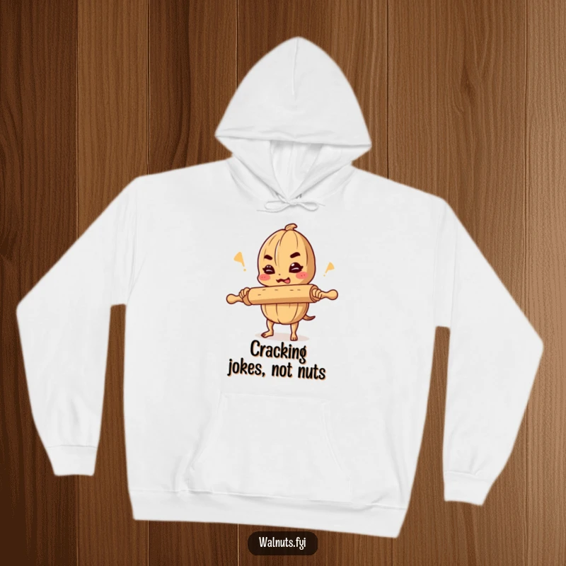 Funny hoodie graphic of a determined walnut cracking a joke while precariously balancing a rolling pin, radiating playful energy.