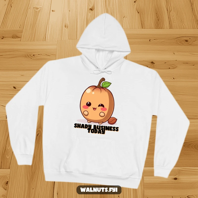 Funny chestnut hoodie featuring a giggling brown character with a mischievous grin hiding playfully behind a large nut, cozy and funny.